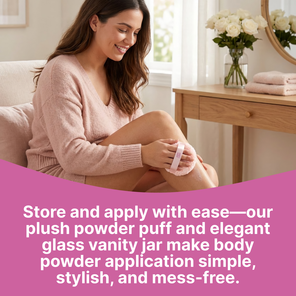 Woman applying body powder to her leg with the Happy Curves Comfort Puff beside a vanity