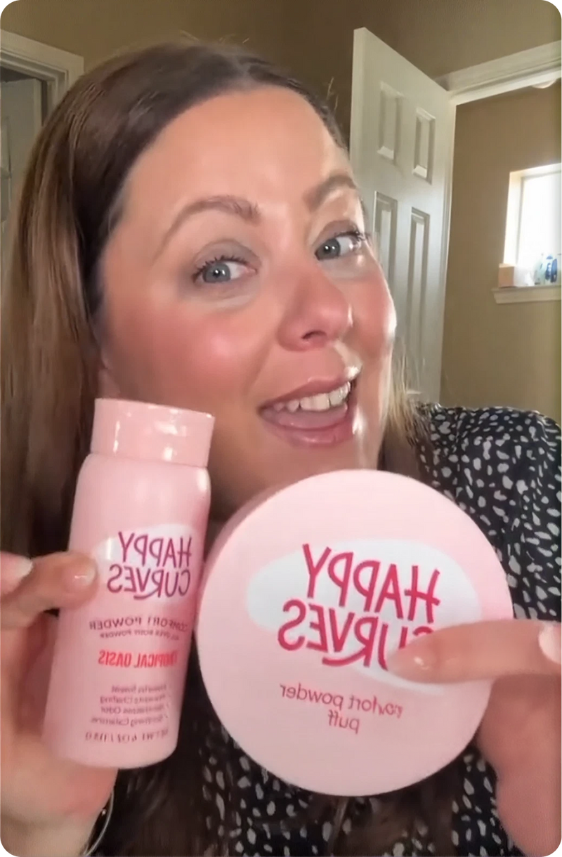 Happy Curves customer holding Comfort Powder and puff